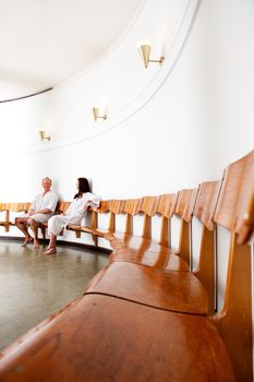 A man and woman in an old european funkis styled spa