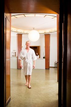 A man in a luxurious old style spa interior