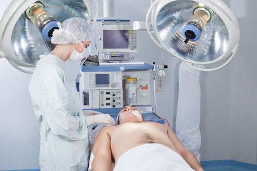 Surgeon checking the patient before operation in operating room