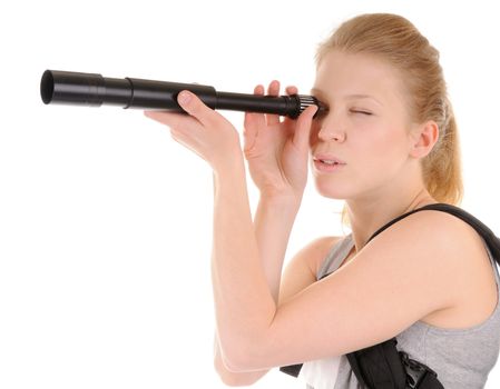 Attractive smiling young woman is looking through telescope on white background