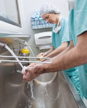 Surgeons washing hands before operation