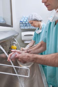 Surgeons washing hands after operation