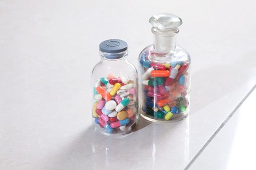 Two bottles with tablets and capsules