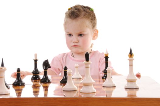 Blonde small girl playing the chess on white background