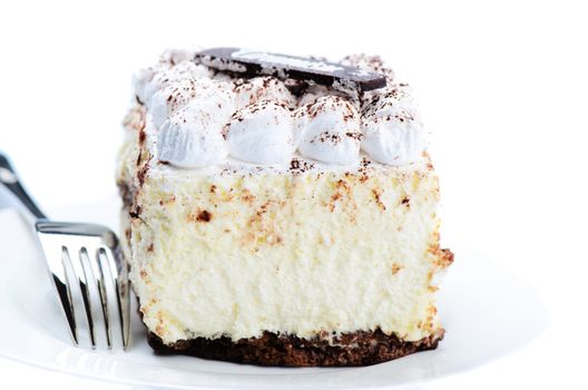 Tasty tiramisu cake on white saucer