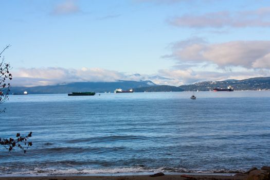 Cargo ships in the harbor at sunset.