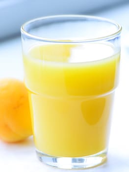 Glass of apricot juice close up