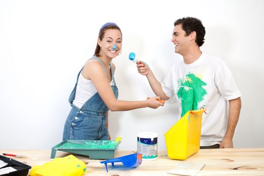 Cheerful couple doing mischief with paint