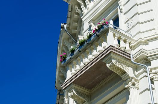 Classical  white building with balcony on a blue sky