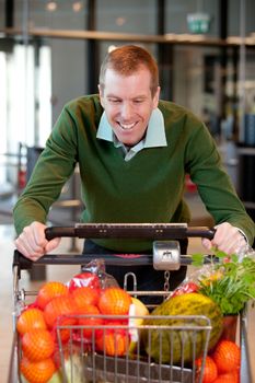 Portrait of a man pushing a grocery cart in a grocery store