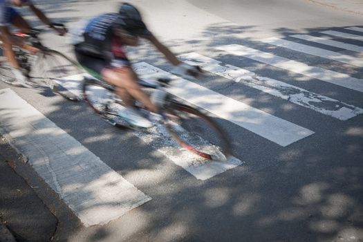 Speedy cyclists in a zebra crossing shortly before the finishing line. Intentional motion blur.