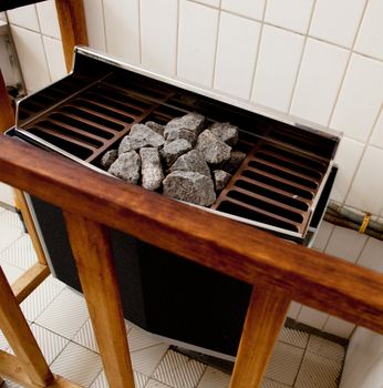 Detail of an electric steam sauna heater with rocks