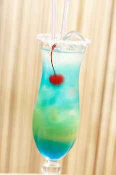 blue cocktail with cherry