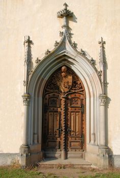 Medieval gothic portal with heraldry carving