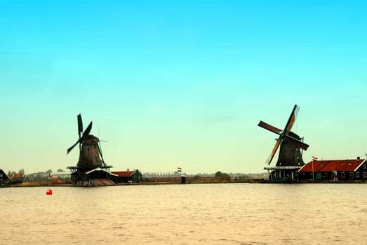 Evening in Holland with a view at pasture with wind mills. Zaandam