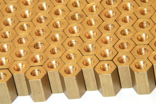 Background made of golden hexadonal screw-nuts