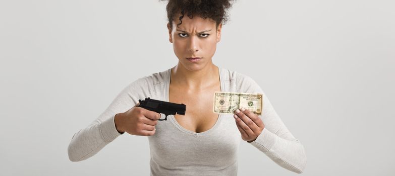 African woman shooting a US-Dollar banknote, great concept for the global crises
