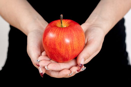 big red apple in woman hands 