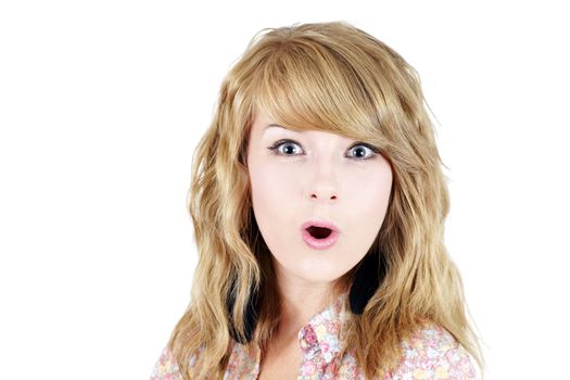 Portrait of a surprised pretty young blond girl teenager isolated over white background