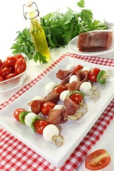 skewers with mozzarella, tomato, basil and ham