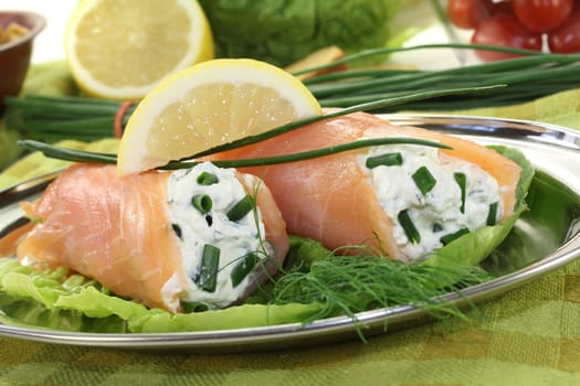 fresh Salmon rolls with cream cheese and chives on a light background