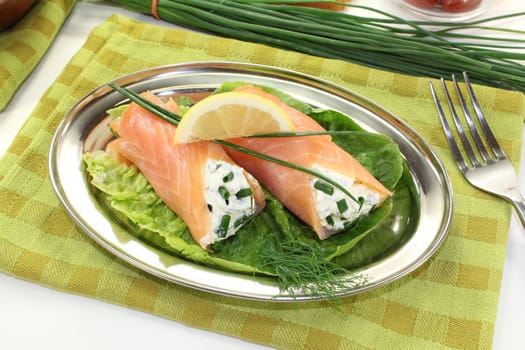 delicious Salmon rolls with cream cheese and chives on a light background