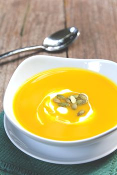 Pumpkin soup with cream and pumpkin seed on top