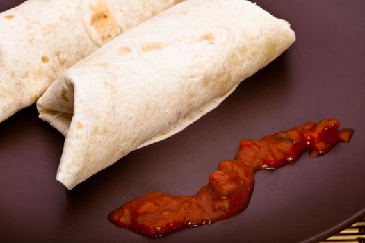 Burritos with chicken pepper onion garlic and sauce