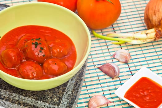 Bowl with meatballs and tomato sauce