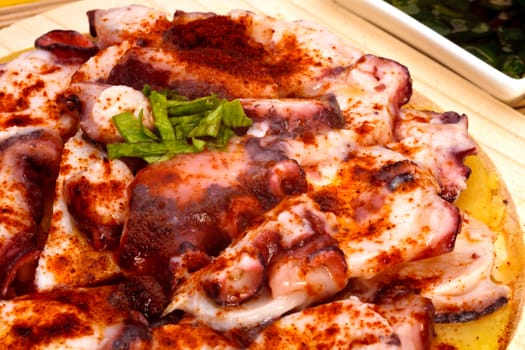 Octopus with paprika, potatoes and olive oil typical of Galicia, Spain