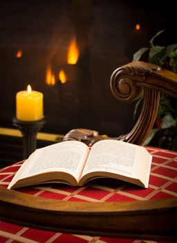 James Joyce 1917 book open on chair in chilly scene with fire and candles in background