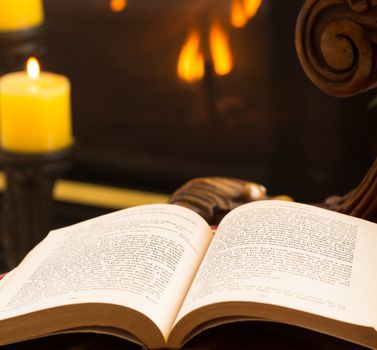 James Joyce 1917 book open on chair in chilly scene with fire and candles in background