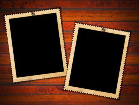 Aged photo frames on wood background with ragged edge

