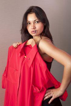 close up of girl which tries on red shirt in shop