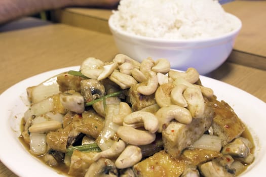 Thai Stir Fry Tofu with Cashew Nuts Onions Mushroom and Cilantro Dish with Rice