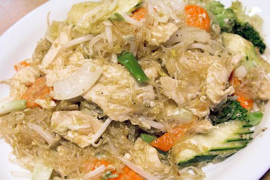 Thai Pad Woon Sen Clear Bean Noodles Stir Fry with Chicken Vegetables Zuchinni Carrots Broccoli and Bean Sprouts Closeup