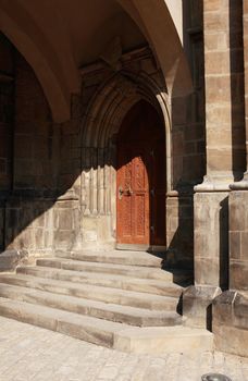 Wall of ancient building with nice wooden door