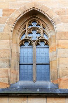 Old stone building wall with nice high gothic window