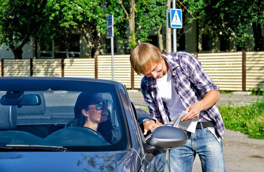 Male tourist asking female driver about direction