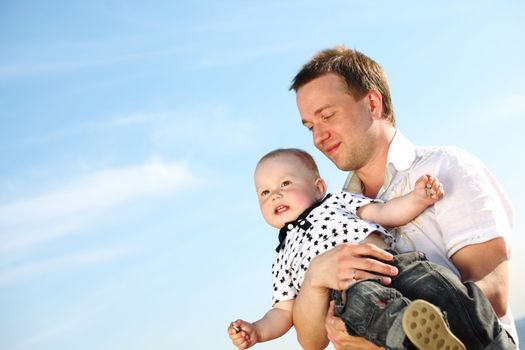 father and son in blue sky
