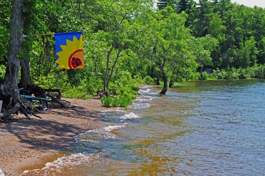 Cottage Beach with Flag to let boaters know that people are at home