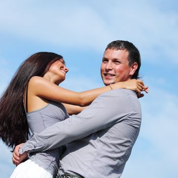 man and woman hug in the sky