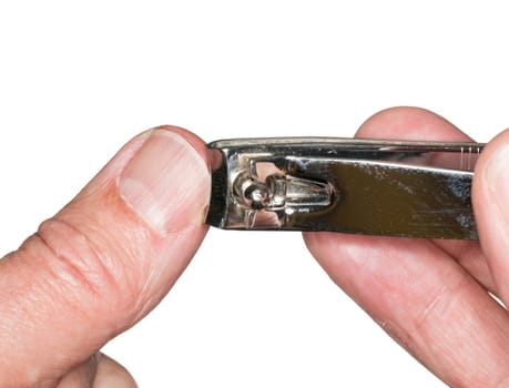 Macro photo of a set of nail clippers cutting thumbnail on senior caucasian thumb