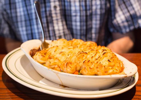 Shepherds or cottage pie with baked mash potatoes in restaurant