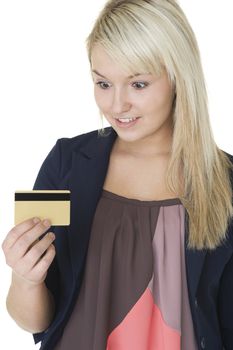 Beautiful blonde woman with a gleeful smlie looking at her credit card with anticipation as she imagines all the purchases she can charge to it
