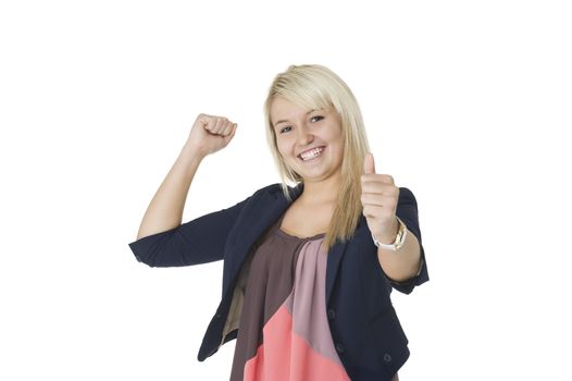 Beautiful elated woman giving a victorious thumbs up and punching the air with her fist in jubilation
