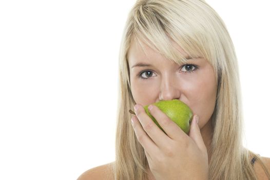 Attractive young blonde woman eating a healthy fresh green pear, studio headshot isolated on white