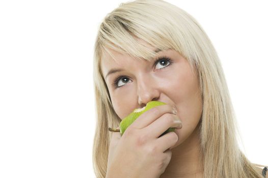 Pretty blonde woman munching on a half eaten green apple and looking up to the sky, isolated on white with copy space