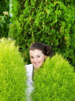 Smilling little girl against green background