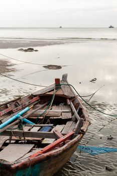 Old boat on beach in overcast sky day evenning time